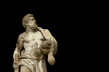 Fototapeta na wymiar Ancient statuue of Hercules on black background