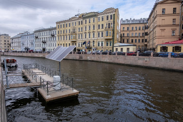Fototapeta na wymiar St. Petersburg, Russia, city center, Moika river. small solar panels on the pier to charge boats and yachts moored in the city. contained electro supply.