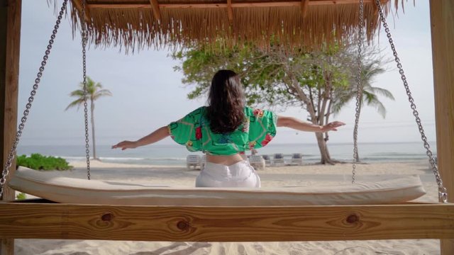 Happy Woman Swinging On Blue Sea Landscape. Carefree Girl Swing On Beach 
