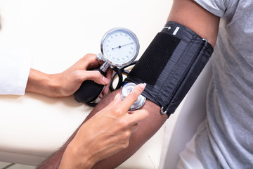 Young Doctor Checking Blood Pressure