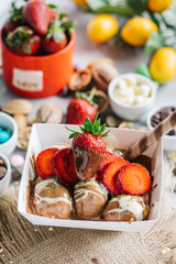 turkish lokma turkish bite dessert with chocolate and white chocolate sauce. strawberry and banana new generation bite