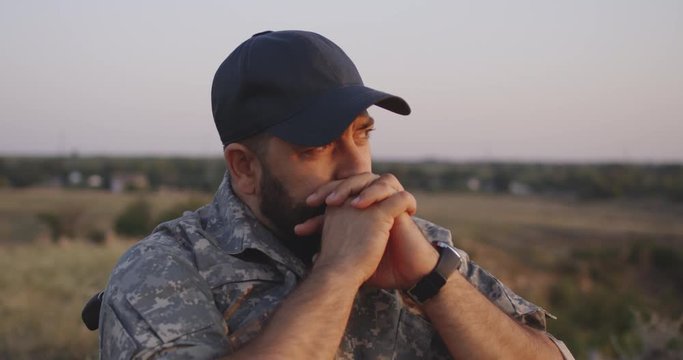 Wheelchaired soldier looking away into distance