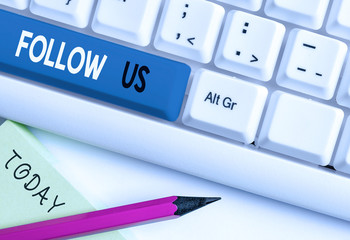 Writing note showing Follow Us. Business concept for Act of demonstrating to invite an individual or group to join his company White pc keyboard with note paper above the white background