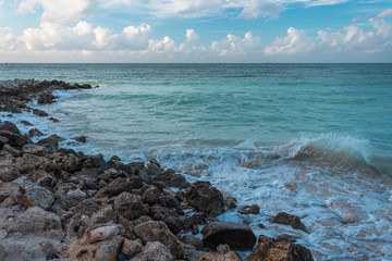 Amazing view of Aruba coast line. Turquoise water of Atlantic ocean merging with blue sky with...