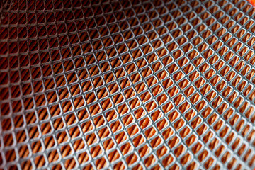 iron mesh frame of paper car air filter, closeup of spare parts with square pattern. background on...