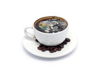 Molded coffee and coffee beans are isolated from a white background.