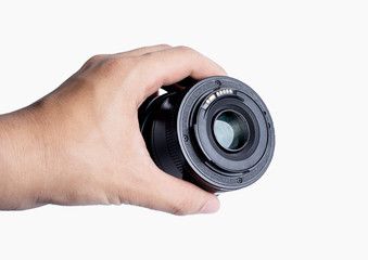 A man's hand holding a 50mm lens. Isolated from a white background.