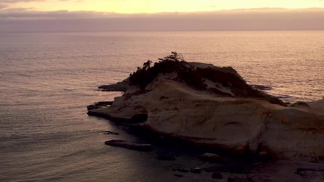 Cinematic aerial flying drone at Cape Kiwanda Pacific sunset