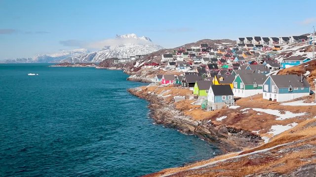 Little fairy town on the shore of the ocean. Small colored houses. Nuuk, Greenland.