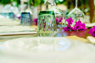 Modern upside down crystal glasses arranged on a banquet table.