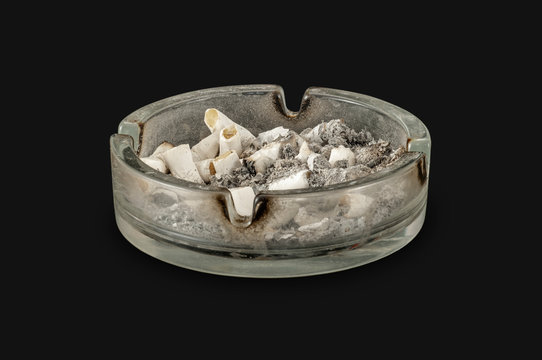 Ashtray filled with cigarettes, isolated on black