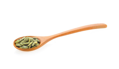 pumpkin seeds  in spoon isolated on white background