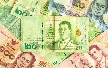 Close up of 20 baht banknotes overlapping with various banknotes