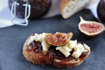 a bruschetta sandwich with onion confiture and cream Camembert cheese on a slice of ciabatta bread