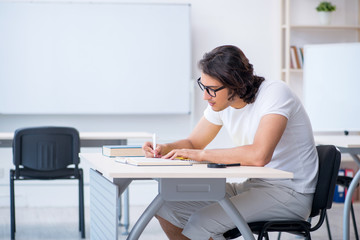 Young male student in front of whiteboard