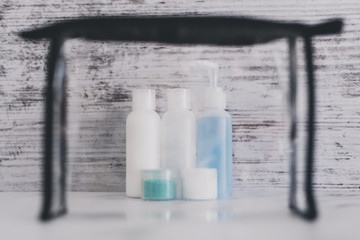 airport screening concept small lotions for liquids and gel next to transparent bag for security compliance