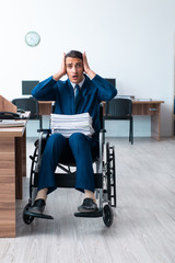 Fototapeta na wymiar Young male employee in wheel-chair