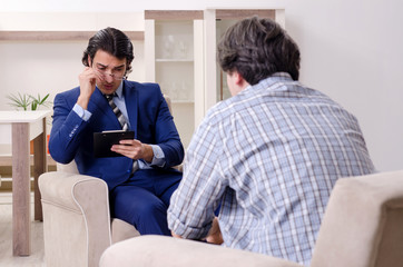 Young male patient discussing with psychologist personal problem