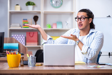 Young male designer working in the office