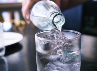 Pure drinking water with ice in glass