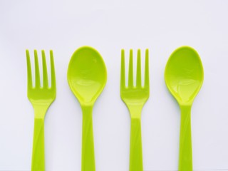 Green Plastic Cutlery, Spoon and fork isolated on white background.