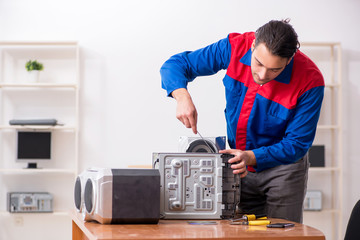 Young engineer repairing musical hi-fi system