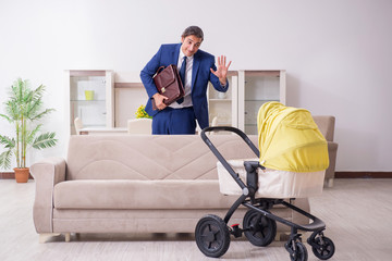 Young businessman looking after baby