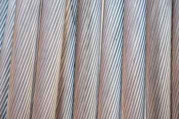 Close up aluminium electricity cable, shiny background. strip texture.