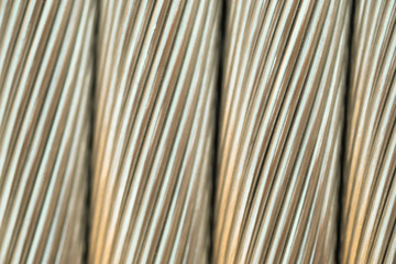 Close up aluminium electricity cable, shiny background. strip texture.