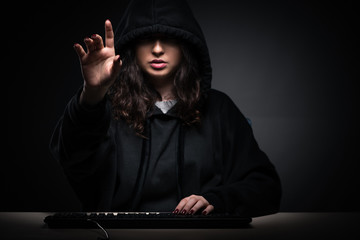 Female hacker hacking security firewall late in office