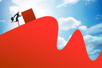 Woman pushing cube towards the top