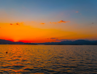 Natural Sunrise Sundown Over Sea Horizon island silhouette