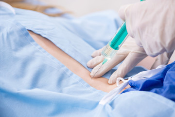 Female patient getting an injection in the clinic