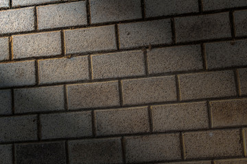 Lighted decorative beige brickwork as a closeup background.
