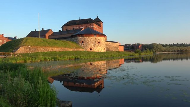 The ancient fortress on the shore of lake Vanajavesi, July morning. Hameenlinna, Finland 
