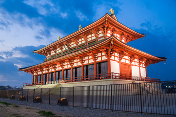 Evening view of The Great Hall of State of Heijo Palace in Nara, Japan (Sign says "Daigokuden" meaning "The Great Hall of State")