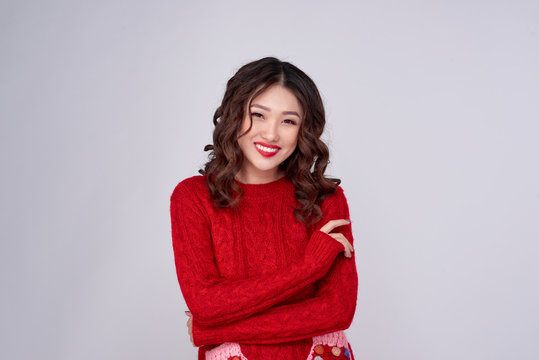Portrait of beauty winter asian girl in red knitted woolen dress. Christmas Holiday.