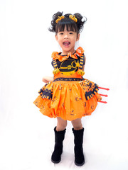 Asian children girl in pumpkin dress costume for Halloween decoration hold Devil's Tree Fork white in  background