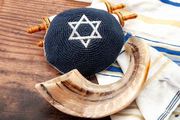 Happy Rosh Hashanah and Yom Kippur conceptual idea with shofar (ram horn), kippah (traditional...