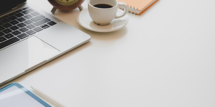 Comfortable workplace with laptop computer, coffee cup and office supplies on white wooden desk - Powered by Adobe