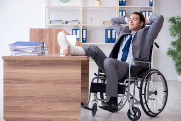 Male employee in wheel-chair in the office