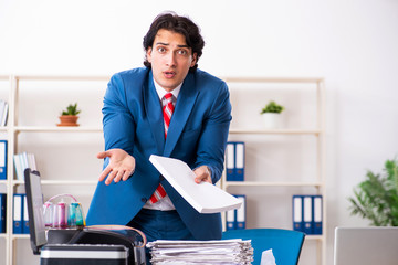 Young employee making copies at copying machine