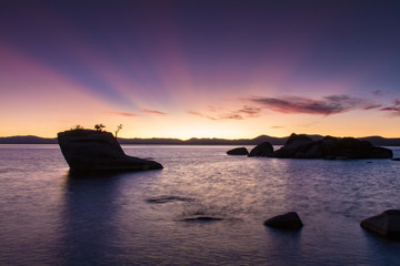 Fototapeta na wymiar Purple Sunset at Bonsai Rock in Lake Tahoe