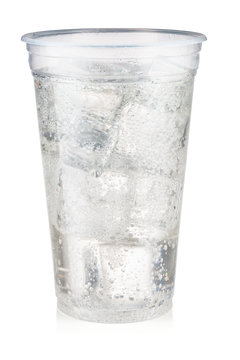 Soda carbonated drink with ice in a plastic cup isolated on white background