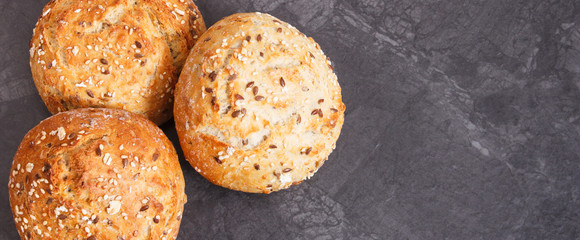 Fresh baked homemade wholegrain rolls or bread, copy space for text