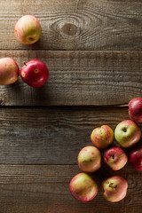 top view of ripe apples on brown wooden surface with copy space