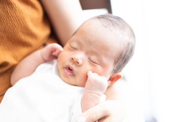 Mother feeding her baby with baby bottle