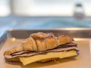 Isolated close up croissant ham and cheese sandwich 