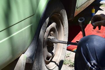 Installing a wheel on an old car.