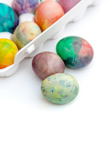 Group of Easter painted eggs in white container